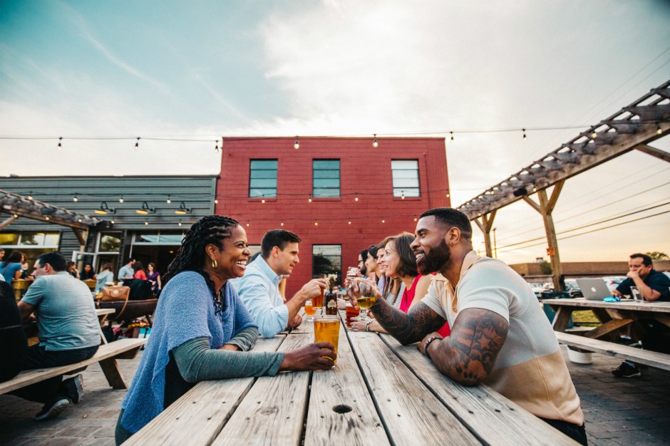 Couple enjoying a beer at Camp North End in Charlotte, North Carolina