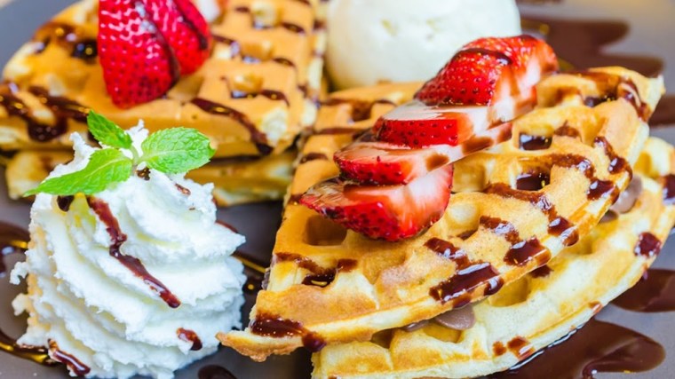 Delectable waffles with strawberries and whipped cream at Harold's Chicken & Ice Bar