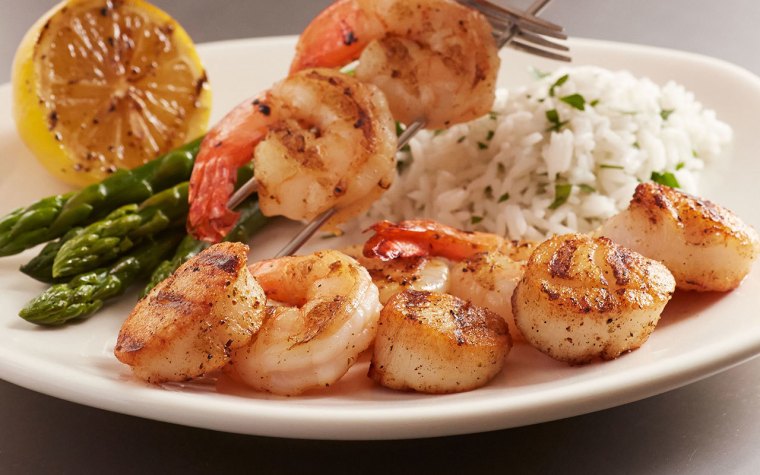 Dinner at Bonefish Grill with grilled shrimp on skewer over jasmine rice with asparagus and charred lemon wedge