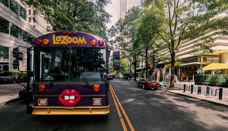 Purple Lazoom Tour bus on city street in Uptown Charlotte, NC