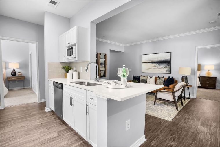 Kitchen island opening up to living area in apartment at The Piedmont in Charlotte, NC